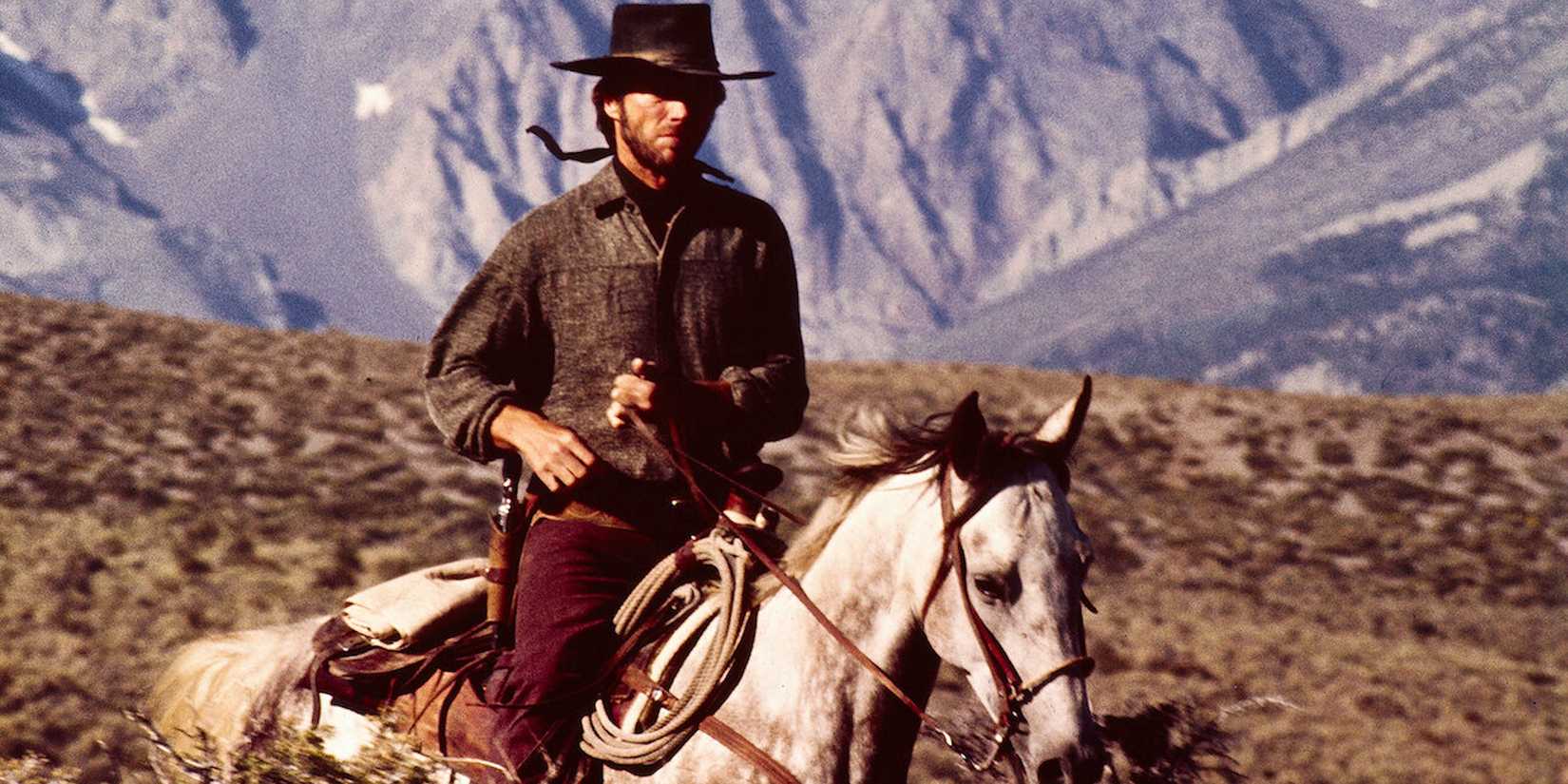 The Stranger riding a horse across the American West in High Plains Drifter