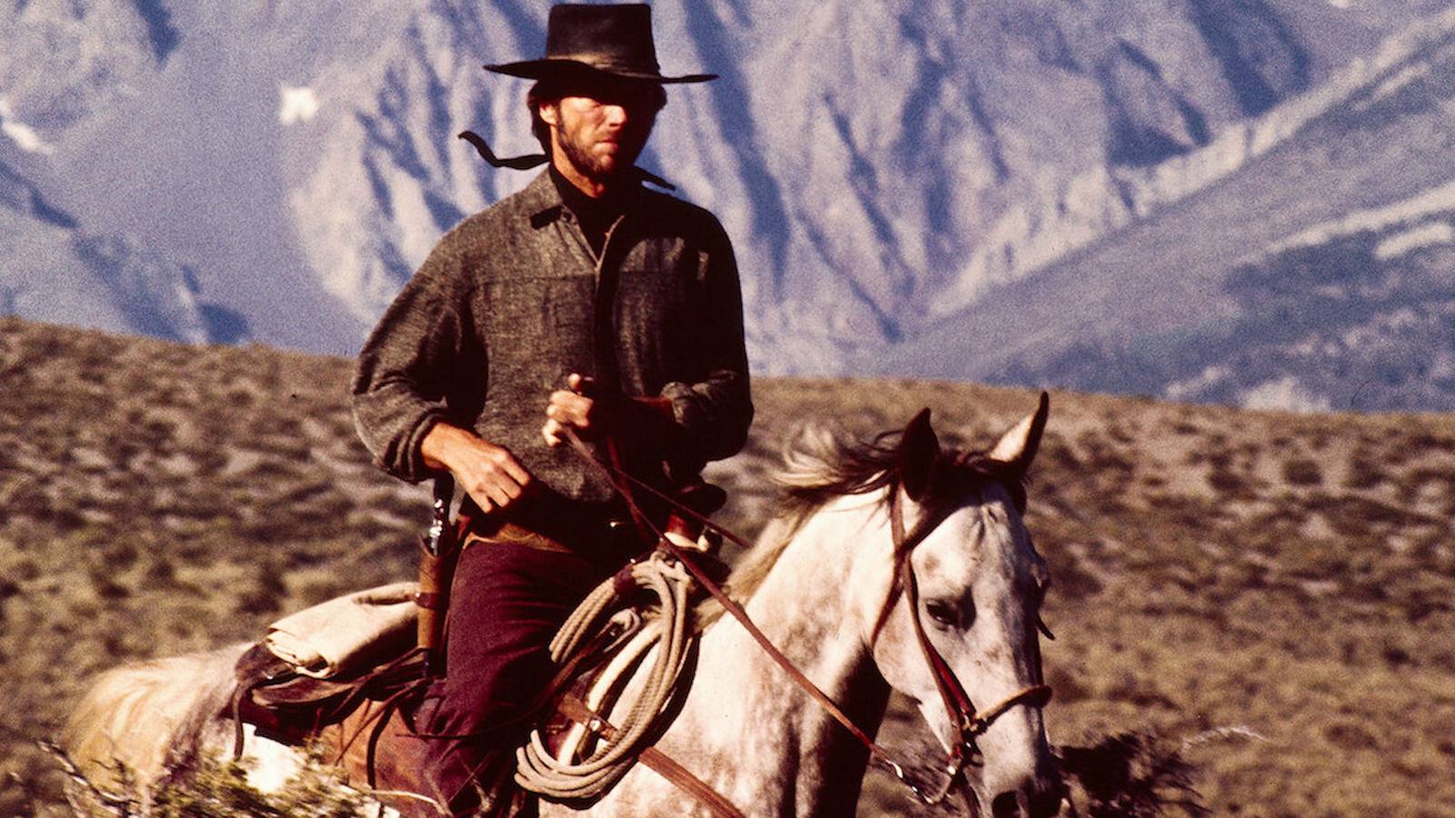 The Stranger riding a horse across the American West in High Plains Drifter