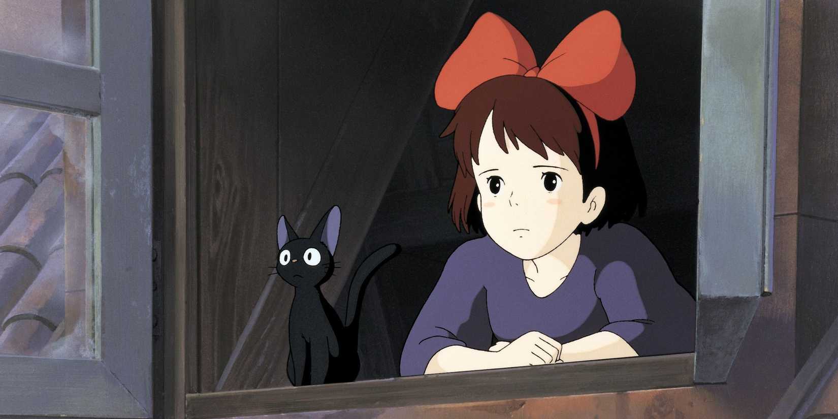 Kiki looking out the window with an expression of longing with a back cat beside her in 'Kiki's Delivery Service' (1989)