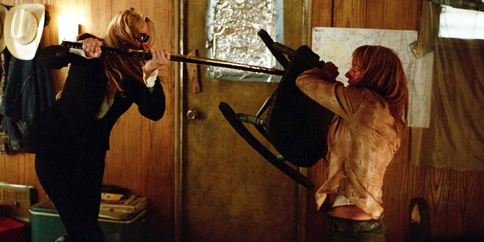 Uma Thurman as The Bride holding up a chair during a fight in Kill Bill Vol. 2