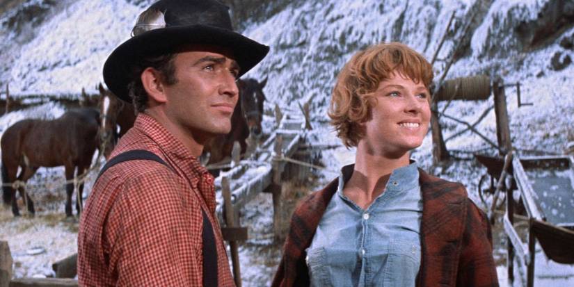 Billy Hammond (James Drury) and Elsa Knudsen (Mariette Hartley) smiling looking to the distance in 'Ride the High Country'