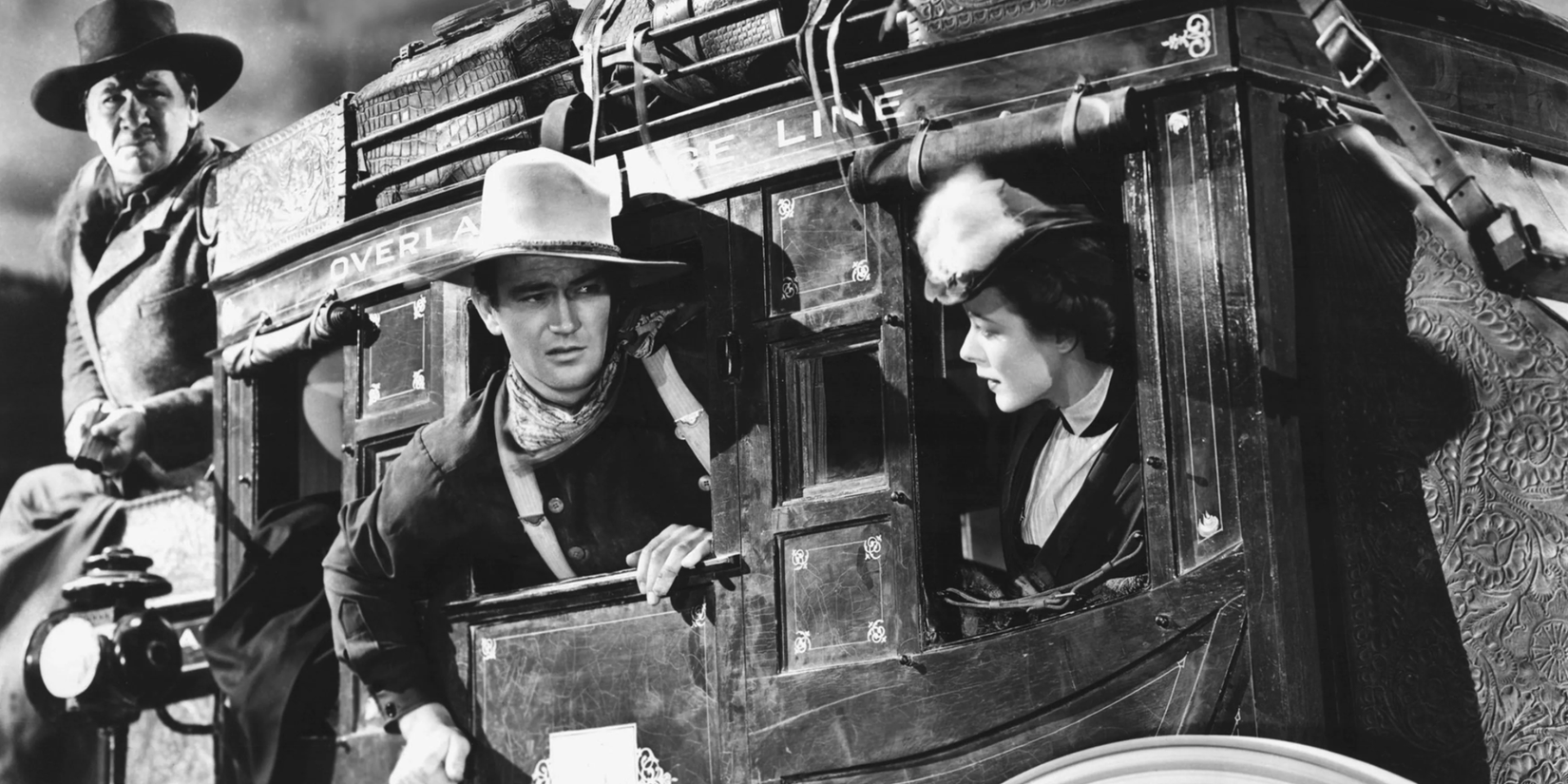 Ringo Kid leaning out the window of a stagecoach in the movie Stagecoach
