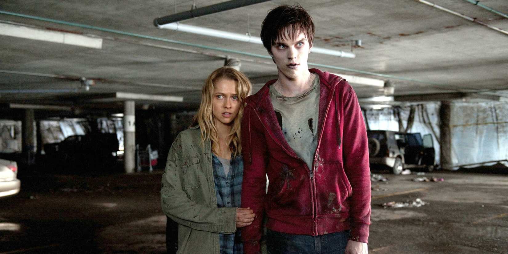 Teresa Palmer looks scared as Julie holding Nicholas Hoult as R's arm in Warm Bodies.
