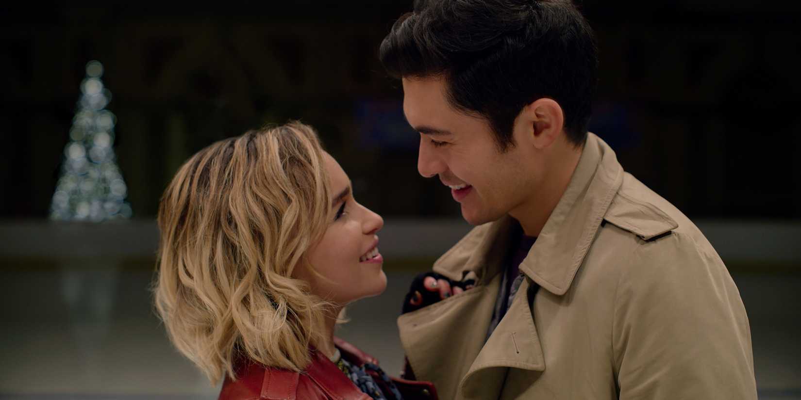 Emilia Clarke and Henry Golding as Katarina and Tom staring lovingly into each other's eyes while smiling in Last Christmas