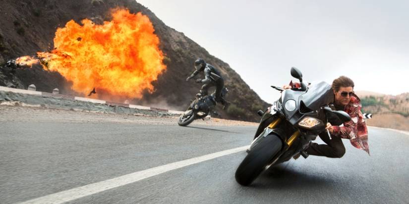 Tom Cruise as Ethan Hunt darts around a corner on a motorbike in Mission: Impossible - Rogue Nation.