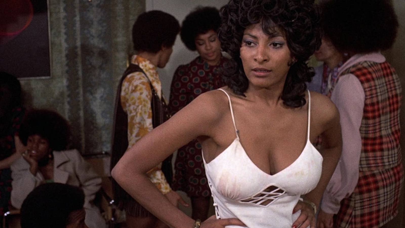 Coffy with her arms on her hips