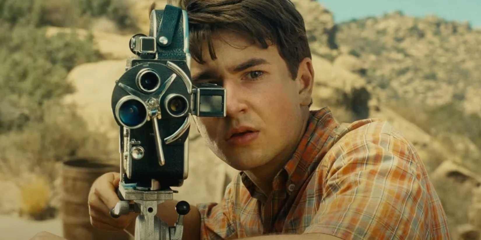 Gabriel LaBelle as Sammy Fabelman looking through a camera in The Fabelmans