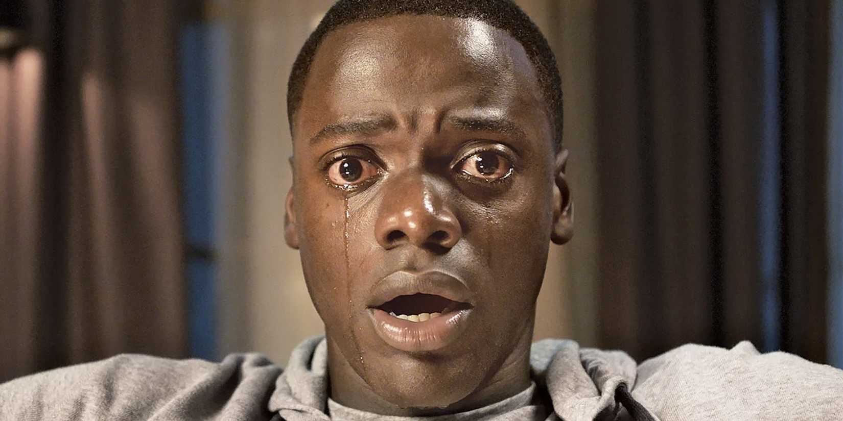 Daniel Kaluuya in 'Get Out' looking scared and shedding tears while his mouth is open in shock.