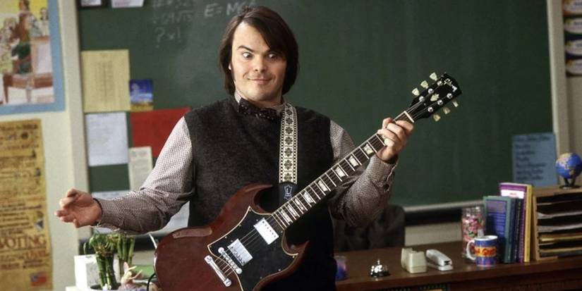 Jack Black as Dewey Finn playing the guitar in front of a classroom in 'School Of Rock'