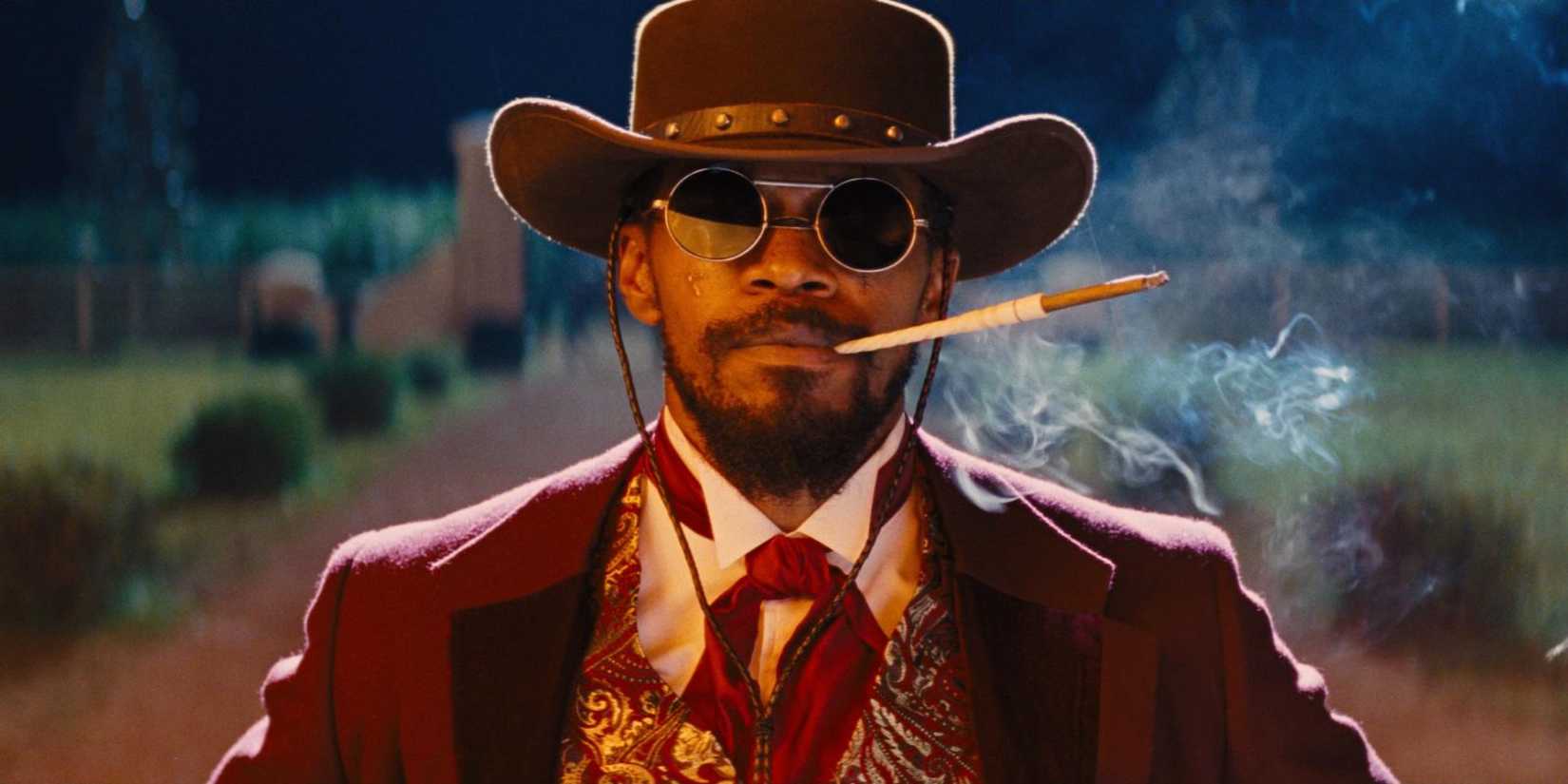 Django lights a cigarette and stands among the ruins of the Candyland mansion in Django Unchained.