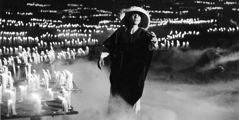 Death stands in a cave surrounded by mist and candles in Macario.