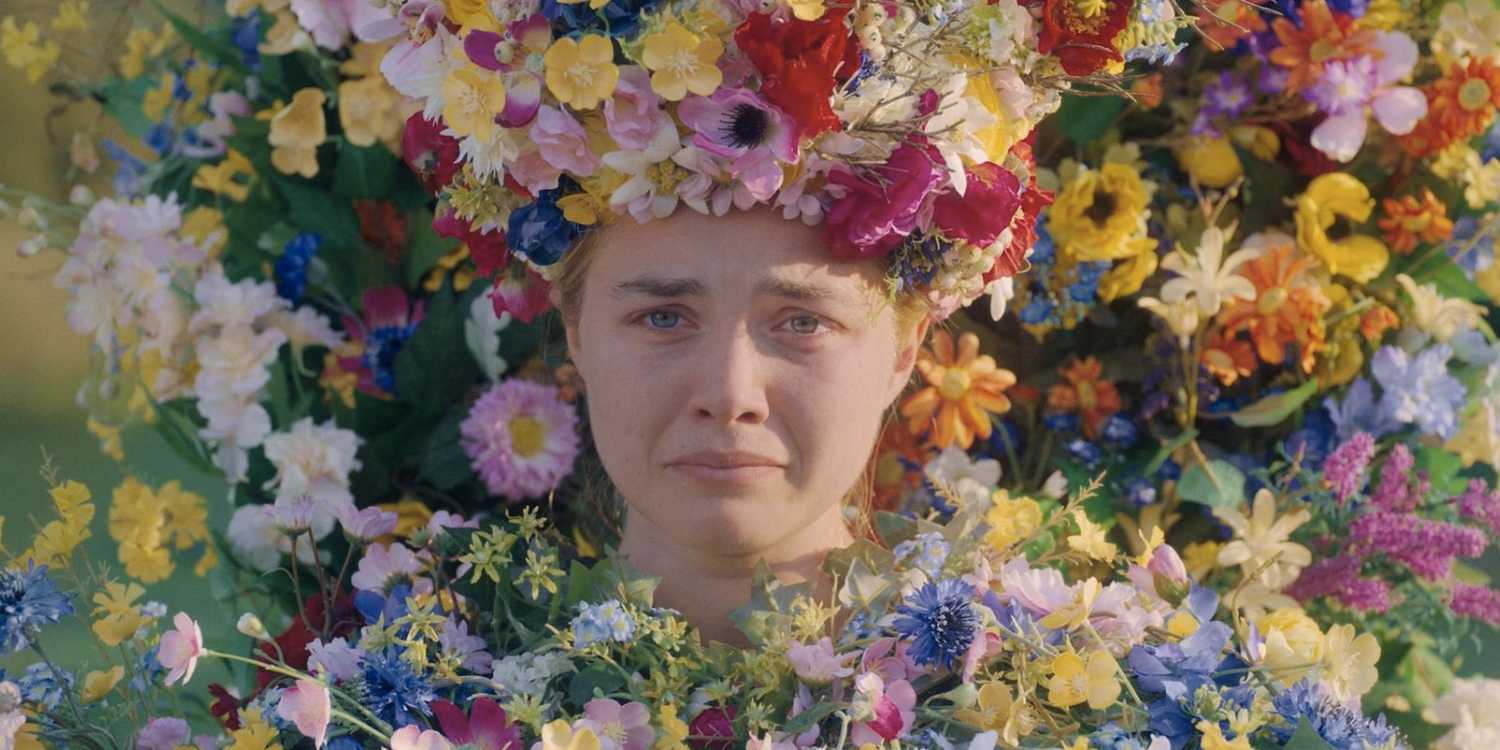 Florence Pugh pouting while surrounded with flowers in 'Midsommar'.