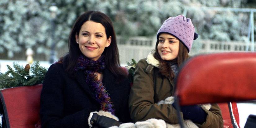 Lorelai and Rory on a sleigh ride across the snow in Gilmore Girls.