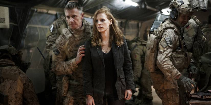 Jessica Chastain as Maya in an army command bunker getting ushered someplace in Zero Dark Thirty