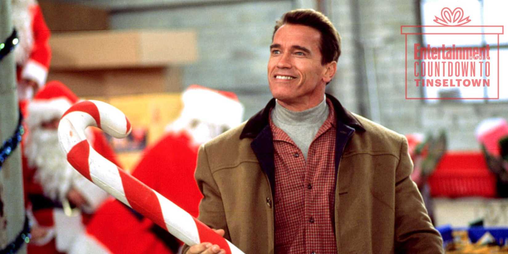 Howard (Arnold Schwarzenegger) holding a huge candy cane from Jingle All The Way