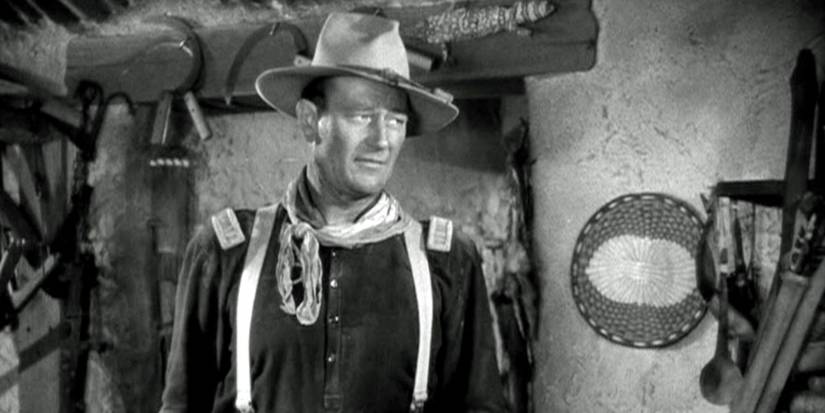 John Wayne standing alone looking to the side in Fort Apache