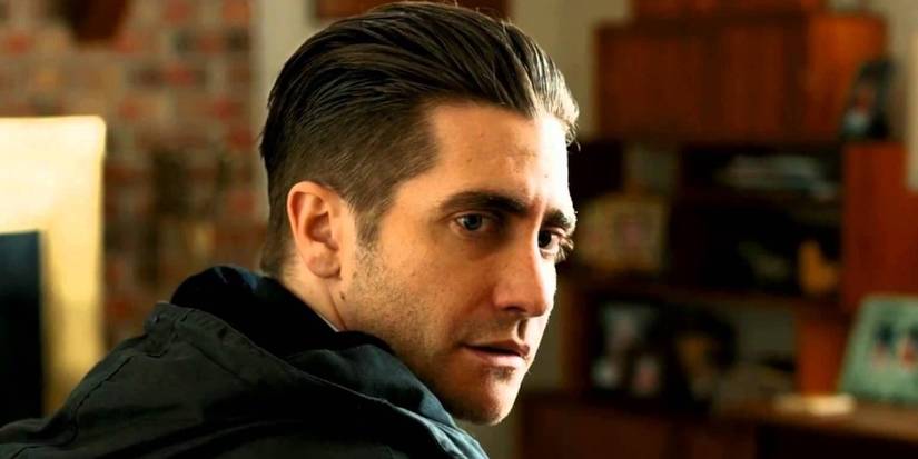 Jake Gyllenhaal as Loki looking back at a person offscreen in Prisoners.