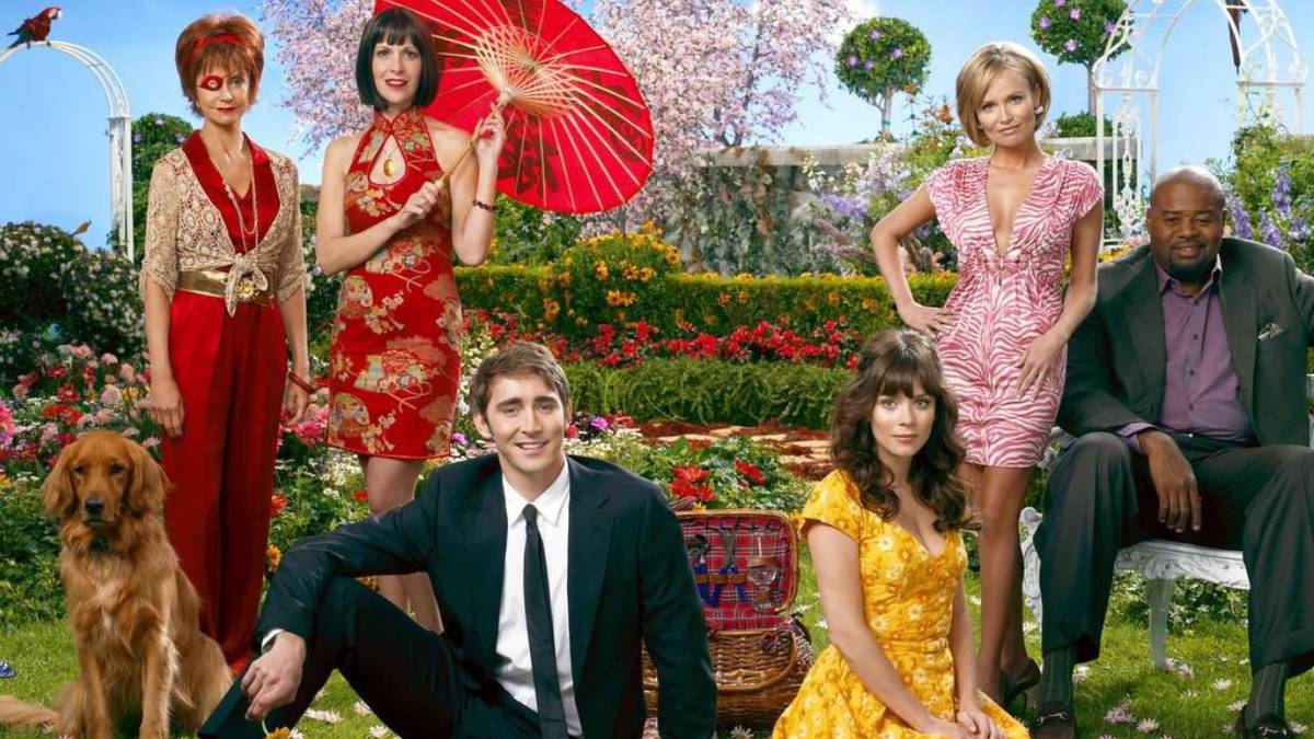 The cast of Pushing Daisies pose for a promotional photo with a lush garden backdrop.