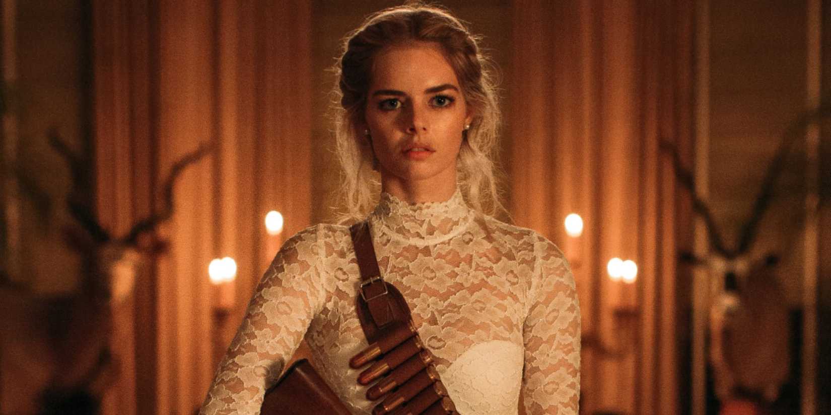 Samara Weaving as Grace wears a wedding dress and a bullet sash in Ready or Not.
