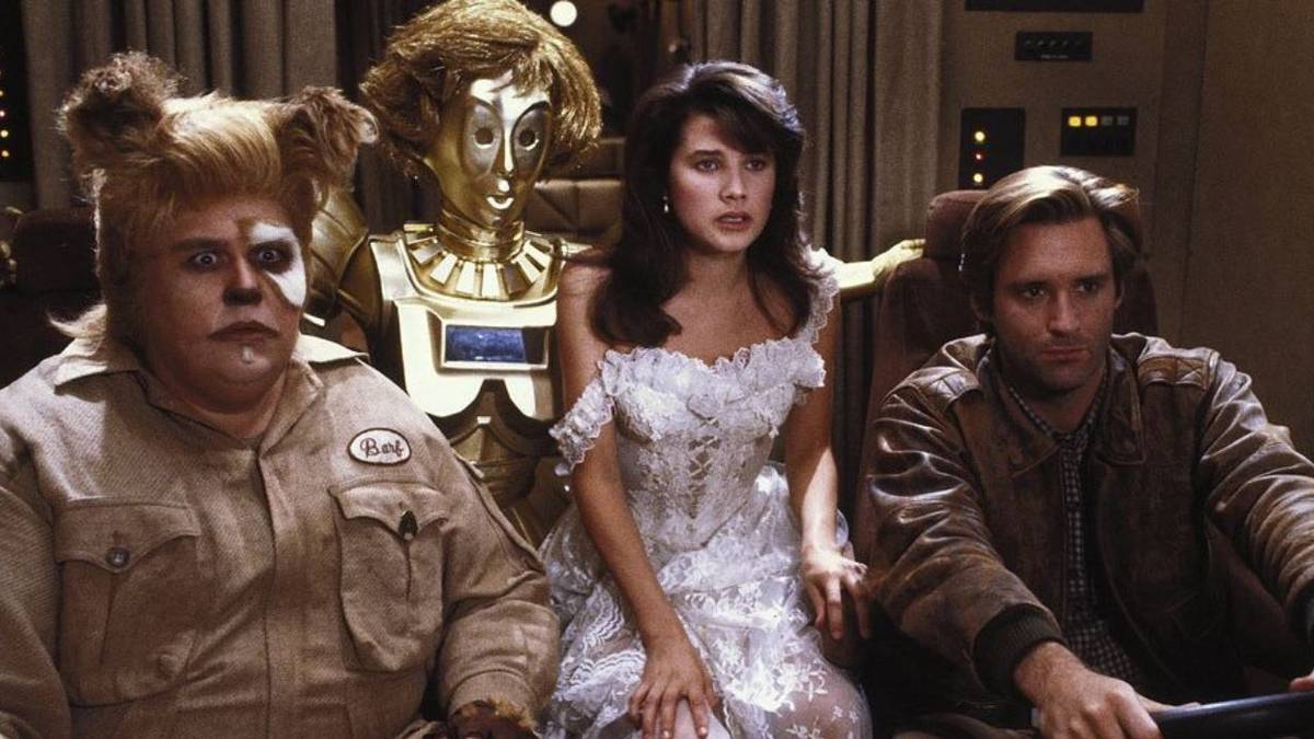Barf (John Candy), Dot Matrix (Lorene Yarnell Jansson), Princess Vespa (Daphne Zuniga), and Lone Starr (Bill Pullman) looking concerned in Spaceballs.