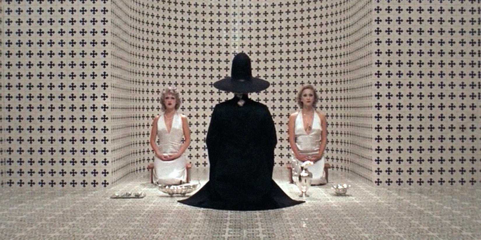 Three figures kneeling on a floor in The Holy Mountain - 1973