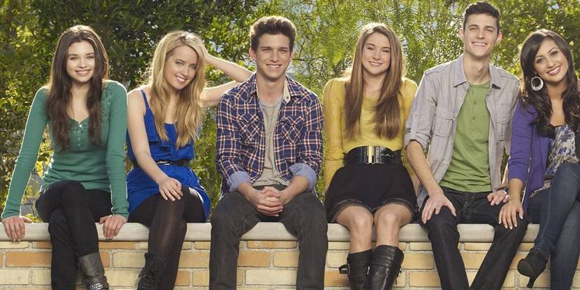 The cast of The Secret Life Of The American Teenager sitting together and posing for a promo photo.
