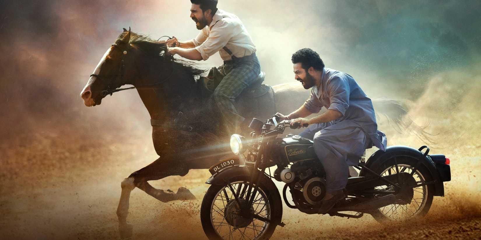 a man on horseback and a man on a motorcycle traversing the desert in RRR