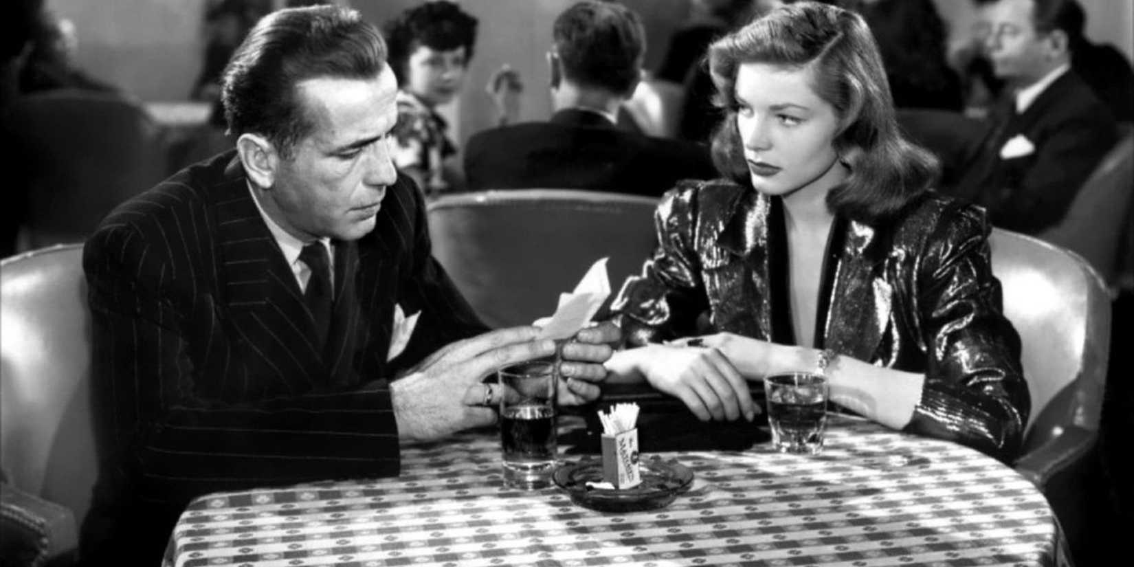 Marlowe (Humphrey Bogart) and Vivian (Lauren Bacall) chat over drinks in 'Key Largo'