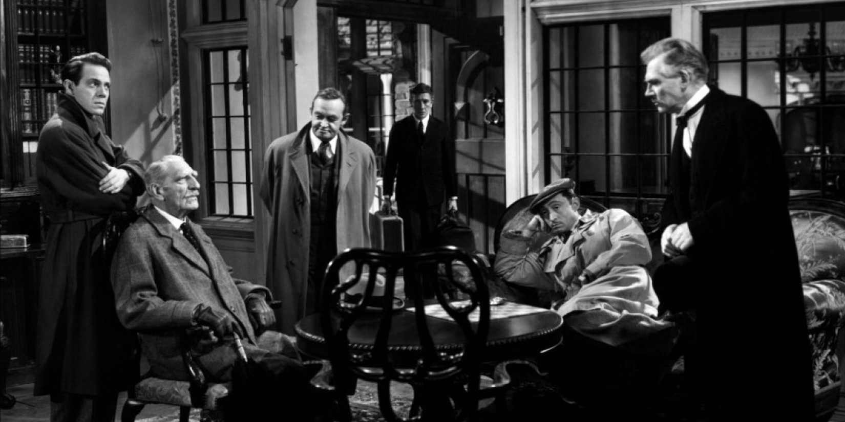 A group of men gather together in a living room to discuss how to protect themselves from the killer.