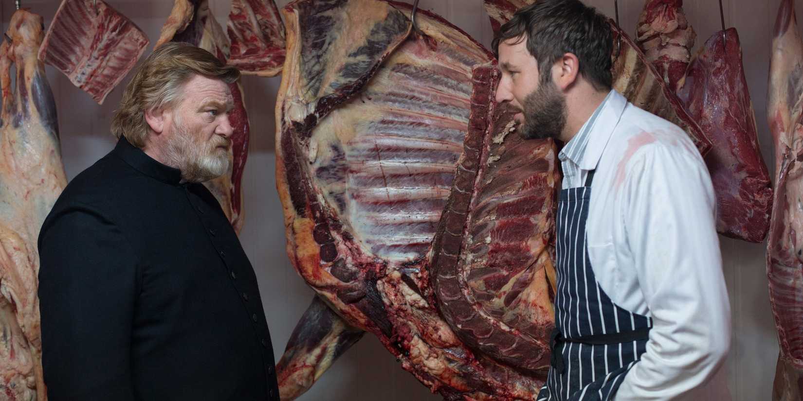 Brendan Gleeson and Domhnall Gleeson talking inside a butcher shop in Calvary.