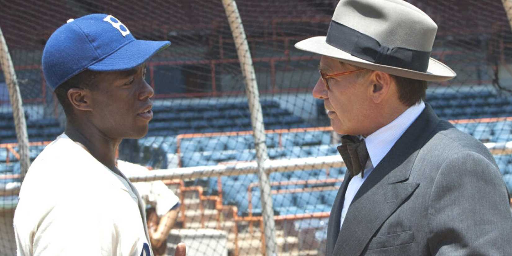 Chadwick Boseman talking to Harrison Ford on the baseball field in 42. 