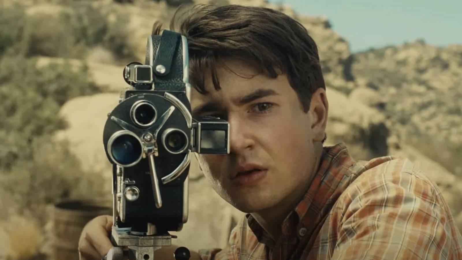 Sammy Fabelman looking through a film camera in 'The Fabelmans'