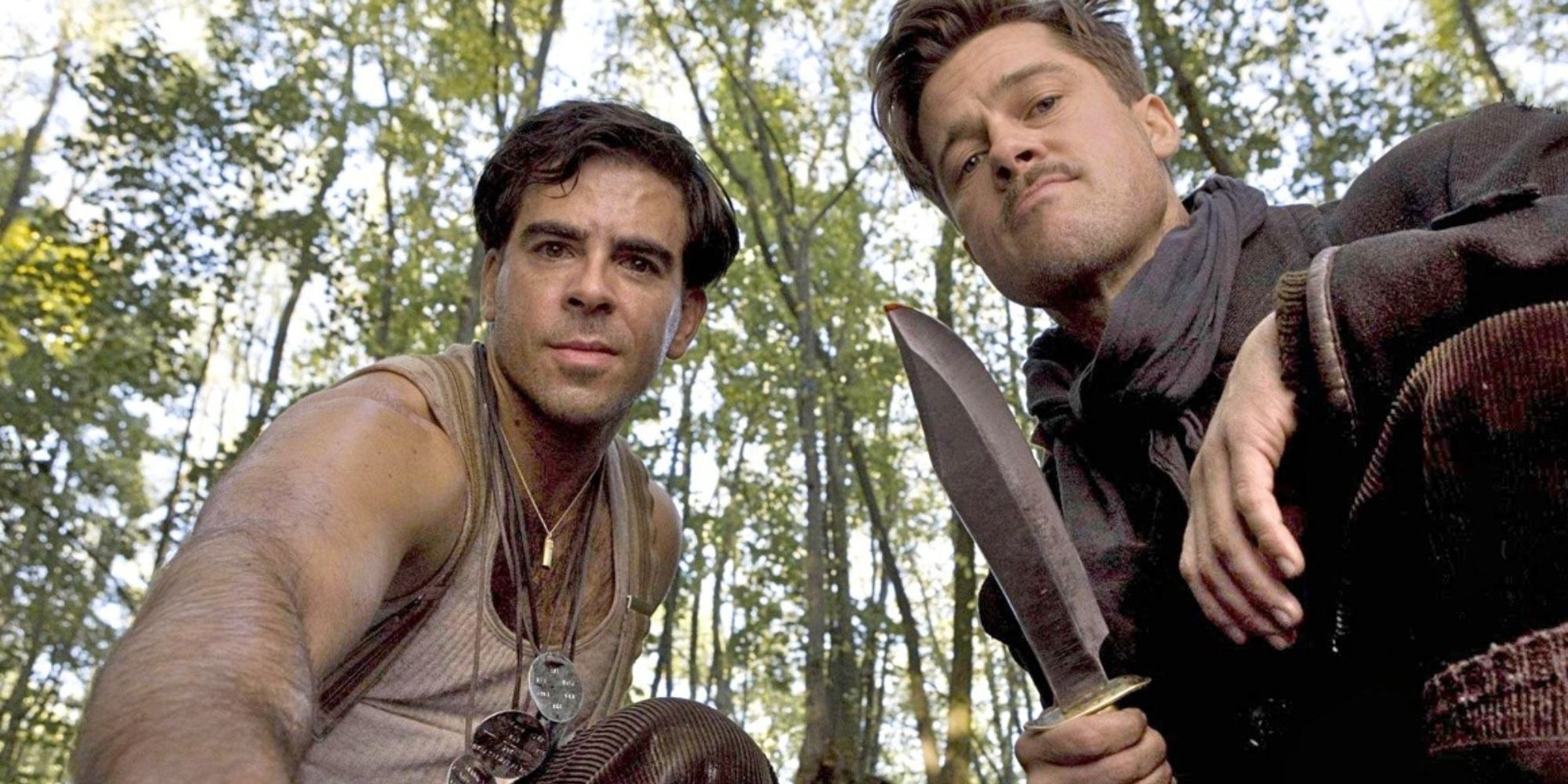 Brad Pitt as Aldo Raine holding up a dagger next to Eli Roth as Donnie Donowitz in Inglorious Basterds.