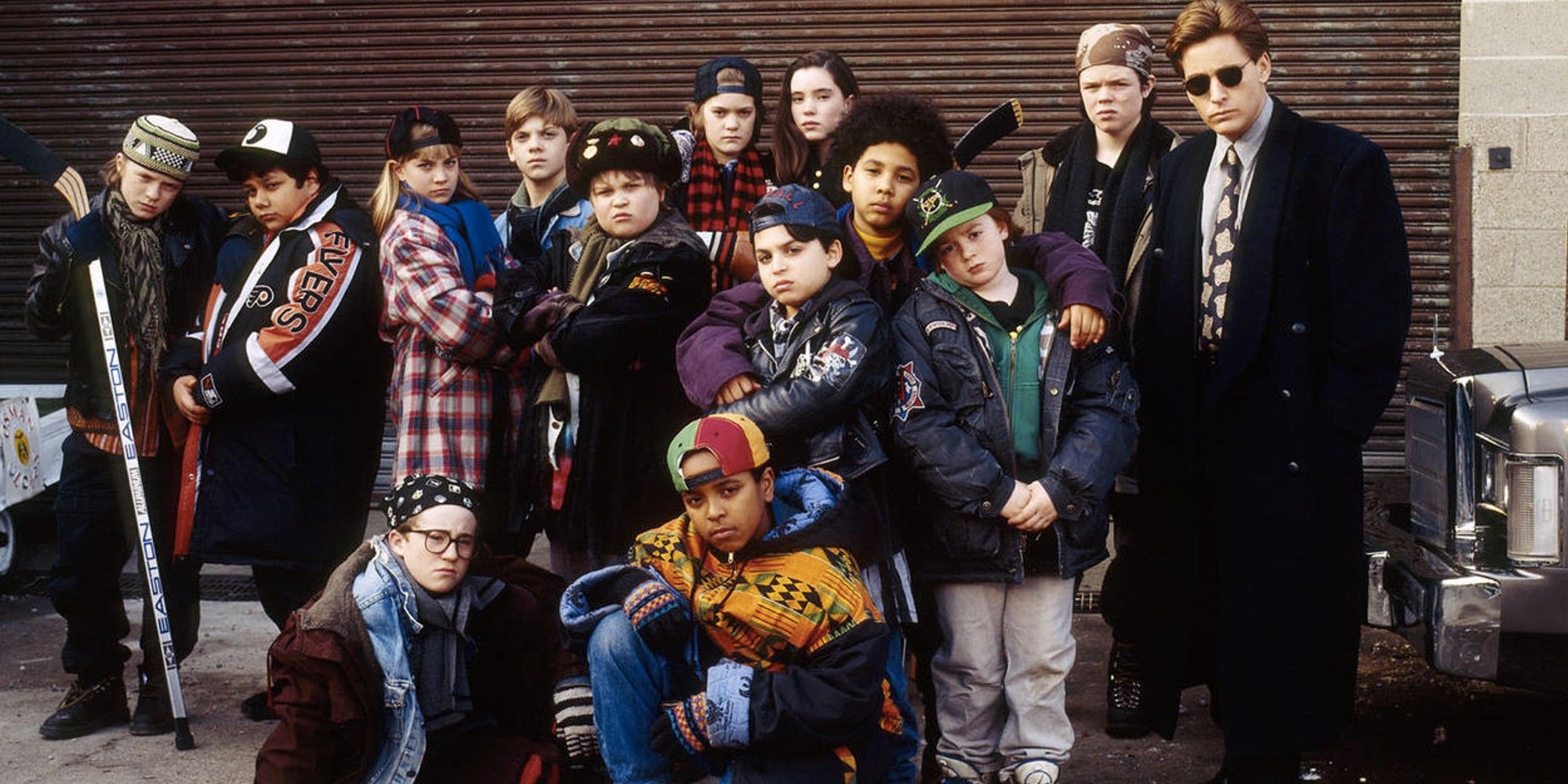 The cast of The Mighty Ducks look in the same direction towards the camera