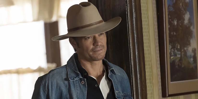 Timothy Olyphant as Raylan Givens smiling softly and looking intently in the show Justified.
