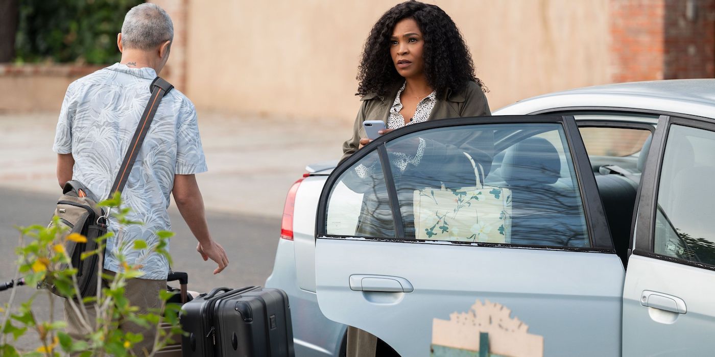 Nia Long standing by a car in Missing