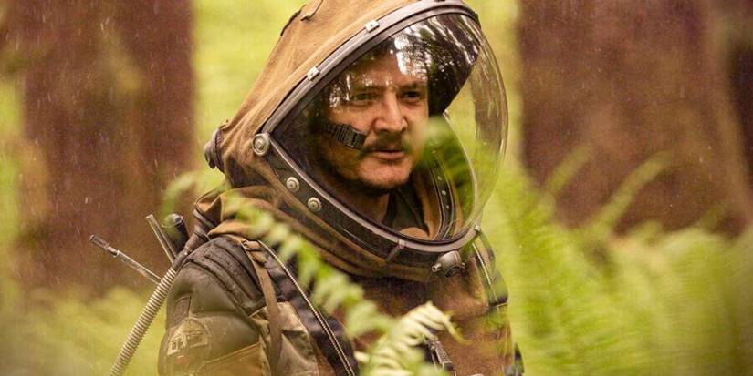 Pedro Pascal as Ezra in a space suit walking through a forest in Prospect.