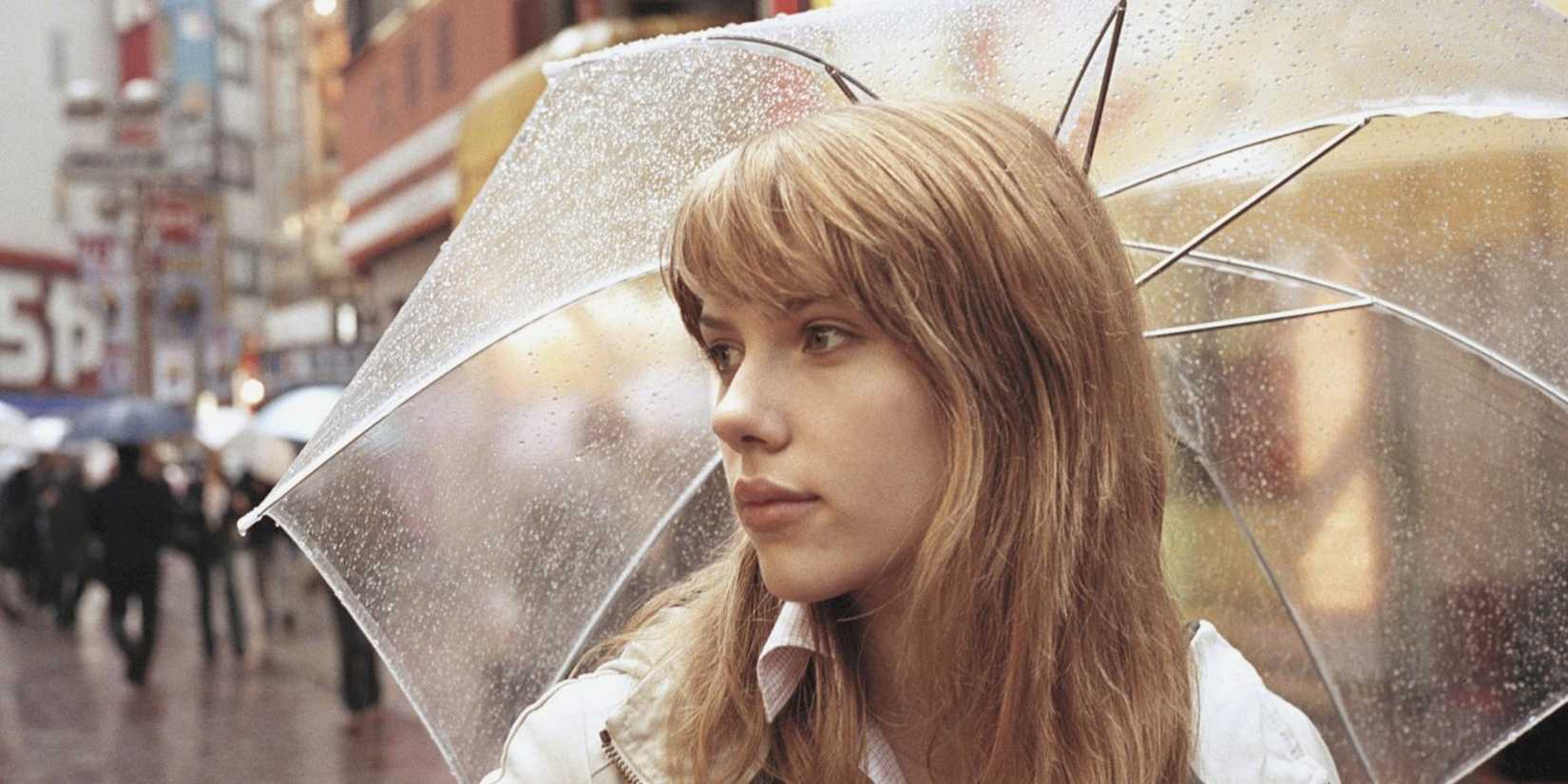 Scarlett Johansson as Charlotte holding an umbrella in 'Lost in Translation' (2003)