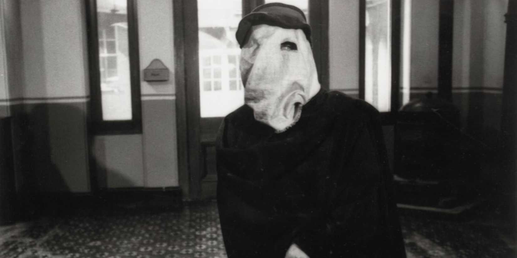 John Hurt as John Merrick standing in a room in The Elephant Man - 1980