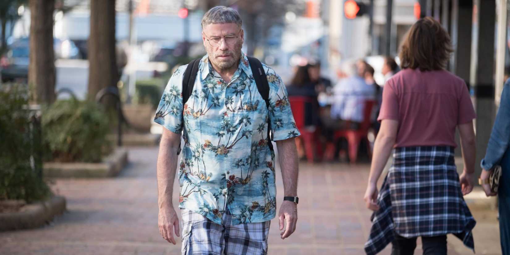John Travolta as Moose, looking glum and walking down the street alone in The Fanatic (2019)