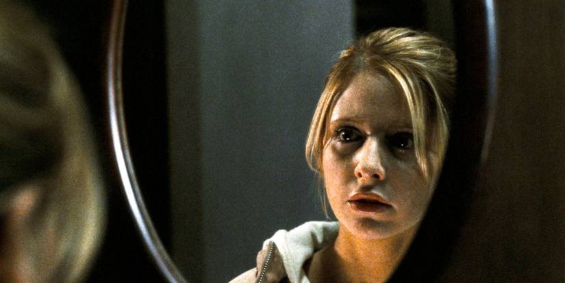 Karen looks frightened as she looks in the mirror in 'The Grudge'