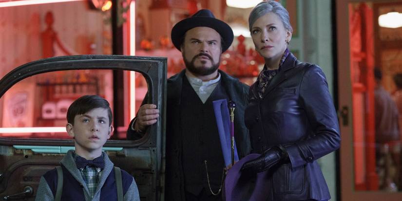 Owen Vaccaro, Jack Black, and Cate Blanchett outside a car and building in The House With a Clock In Its Walls