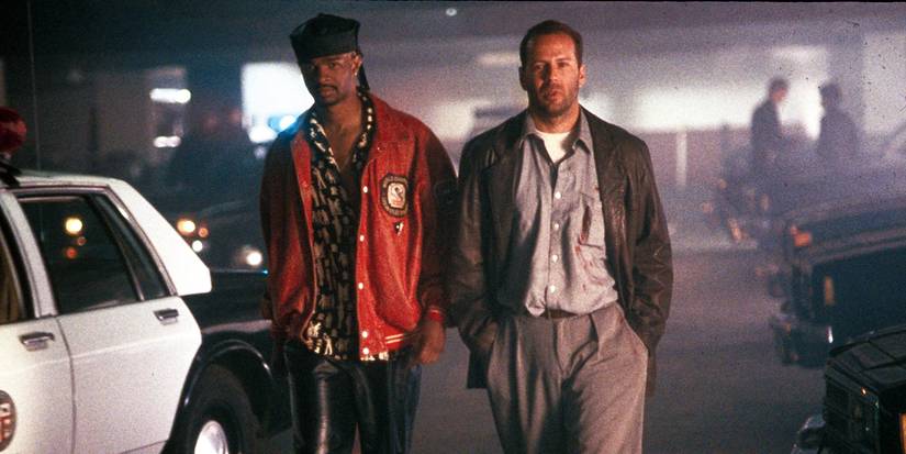 Bruce Willis and Damon Wayans standing in a parking lot in 'The Last Boy Scout.'