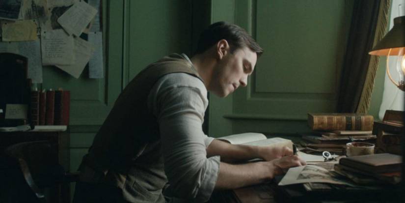 Tolkien writes at a desk