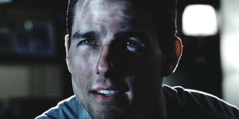 Tom Cruise as John Anderton looking up towards a reflection in Minority Report (2002).