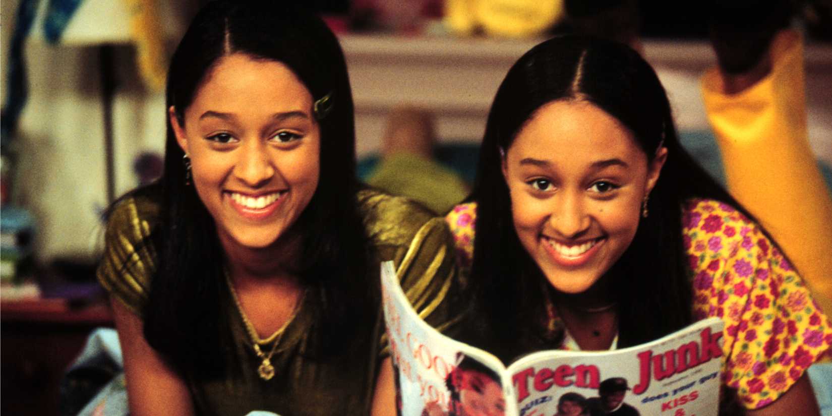 Twins Tia and Tamara Mowry are next to each other while one holds a magazine on Sister, Sister.