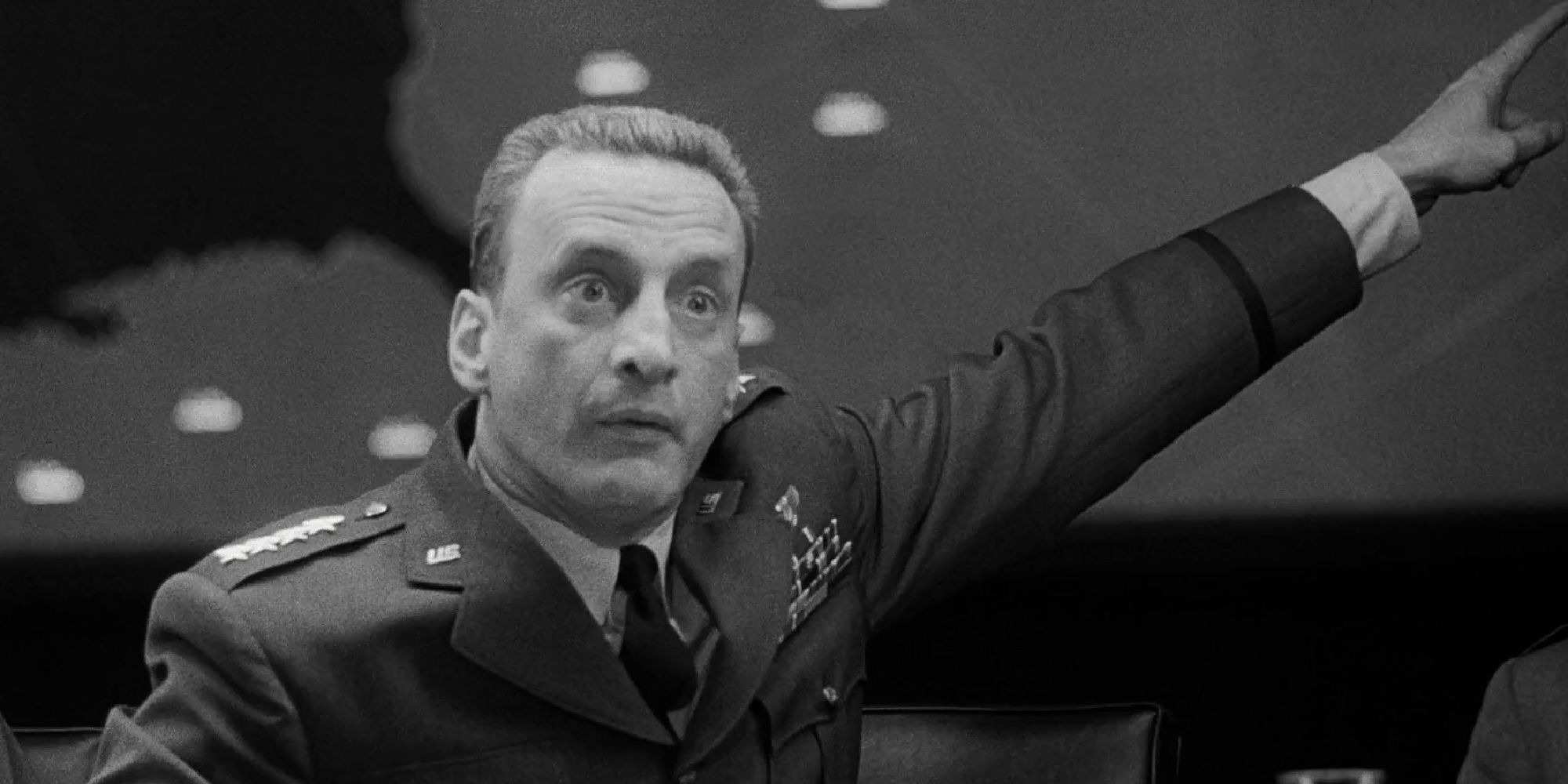 George C. Scott as Gen. 'Buck' Turgidson adamantly pointing up and offscreen in Dr. Strangelove