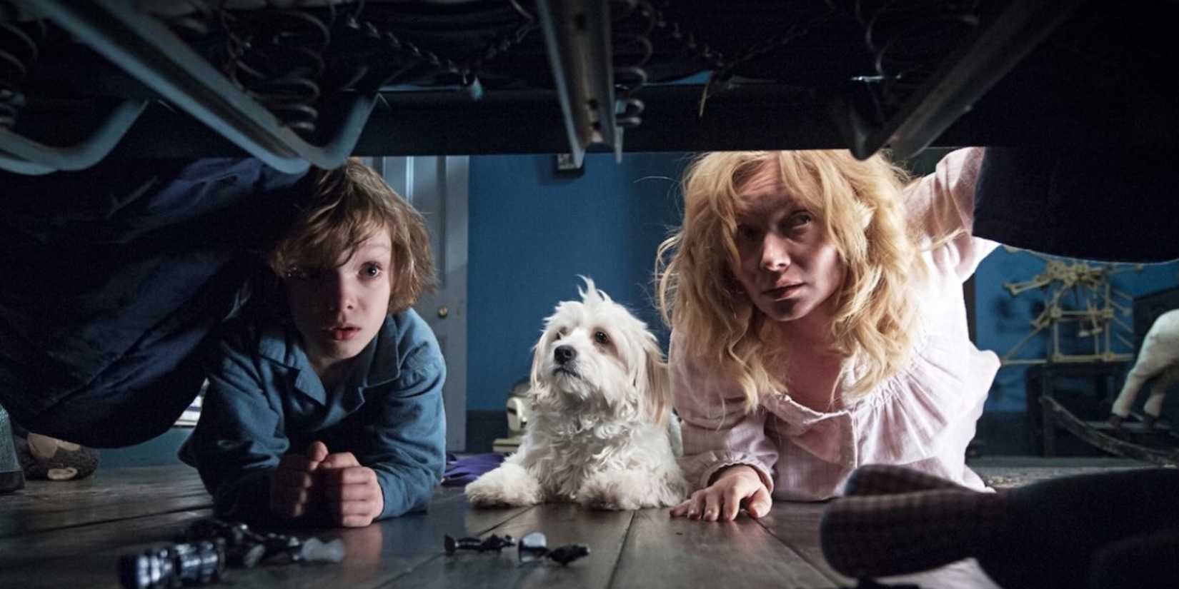 Essie Davis and Noah Wiseman looking under the bed with the dog in 'The Babadook'