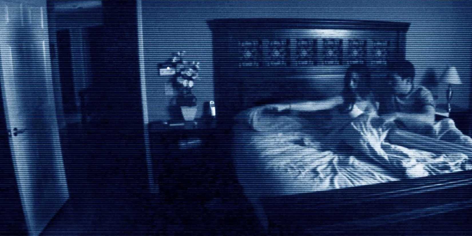 Footage of Katie Featherston and Micah Sloat as Katie and Micah, sitting on their bed as she points her finger to the door in 'Paranormal Activity'