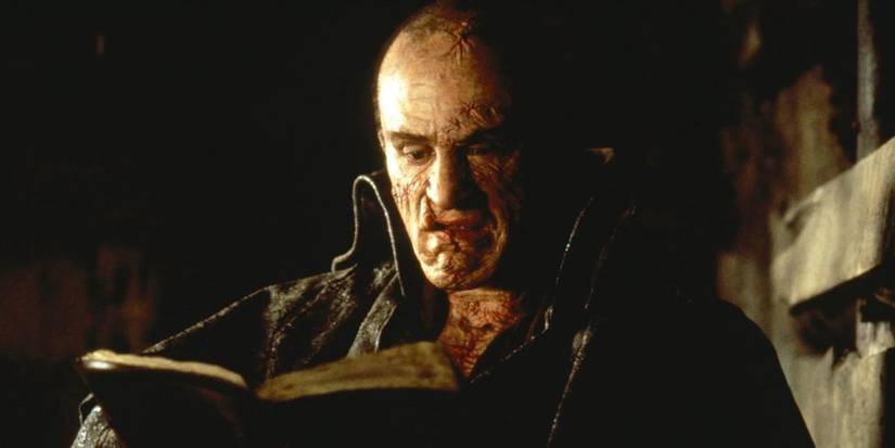 The creature, played by Robert De Niro, reading a book in 'Mary Shelley's Frankenstein'